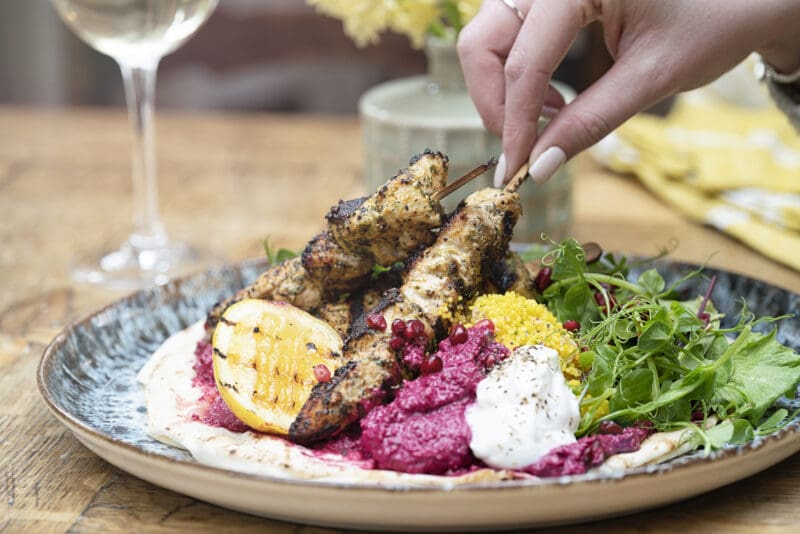 GRILLED FLATBREAD Marinated chicken Beetroot hummus, cous cous, greek yogurt, mixed leaf salad, pomegranate seeds